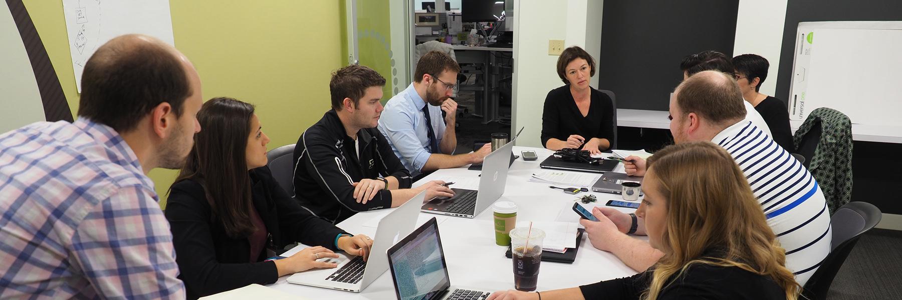 McKinney law students and professor sitting around a table discussing one of the clinic cases